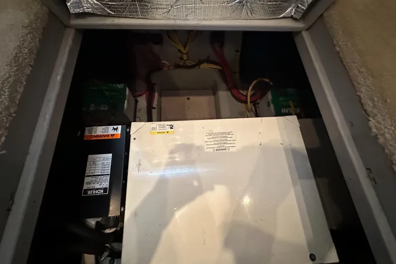 Slide: The Image of Engine compartment of 2002 Silverton 35 Convertible boat, showing machinery and wiring. - 34