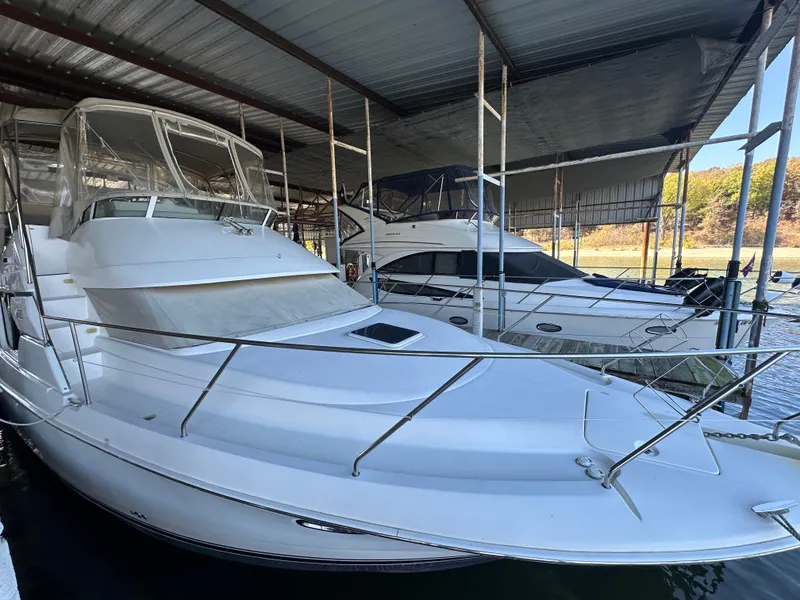 Slide: The Image of 2002 Silverton 35 Convertible yacht docked in covered marina. - 7