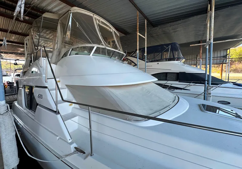 Slide: The Image of 2002 Silverton 35 Convertible yacht docked in covered marina. - 8