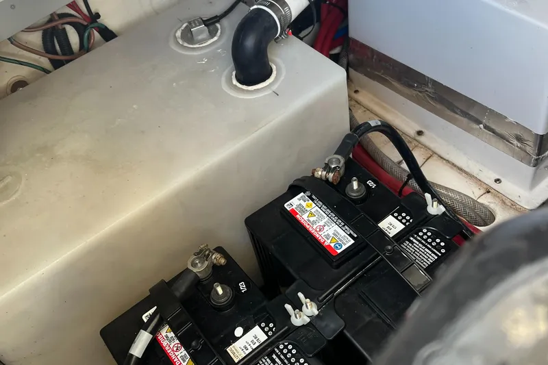 Slide: The Image of 2021 Regal 28 Express boat engine compartment with batteries and fuel tank. - 10