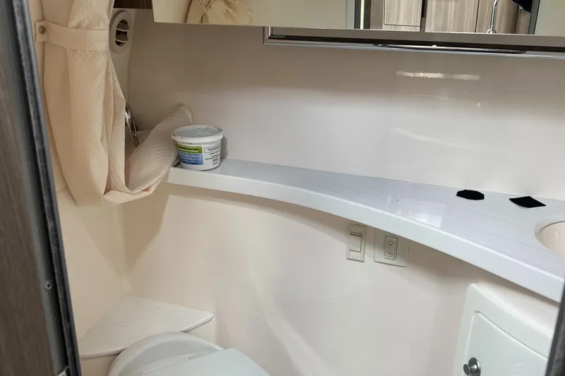 Slide: The Image of 2021 Regal 28 Express bathroom interior with modern fixtures and storage. - 14