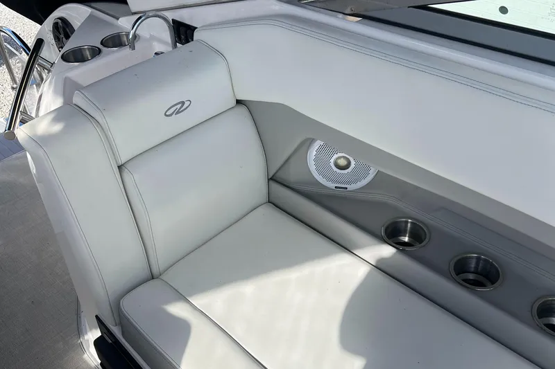 Slide: The Image of 2021 Regal 28 Express boat interior with white seating and cup holders. - 18
