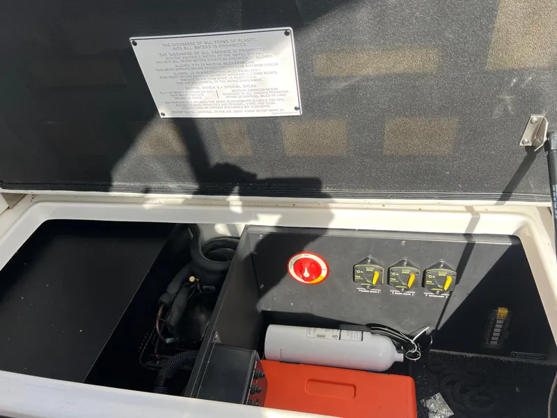 Slide: The Image of 2021 Regal 28 Express engine compartment with control panel and safety equipment. - 20