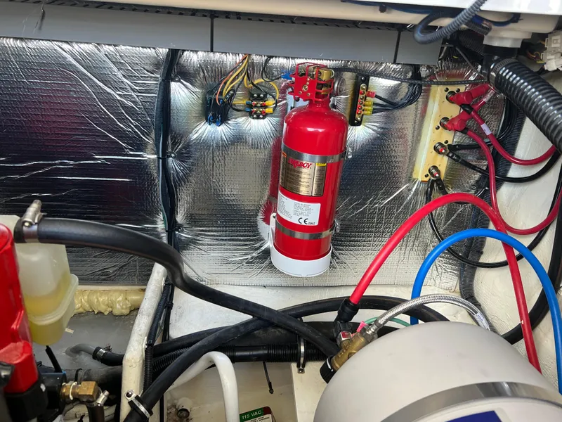 Slide: The Image of Engine compartment of 2021 Regal 28 Express with fire extinguisher and wiring. - 24