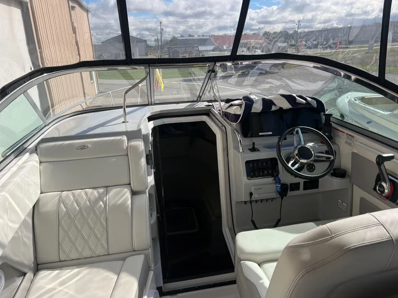 Slide: The Image of 2021 Regal 28 Express boat interior with white seating and steering console. - 26