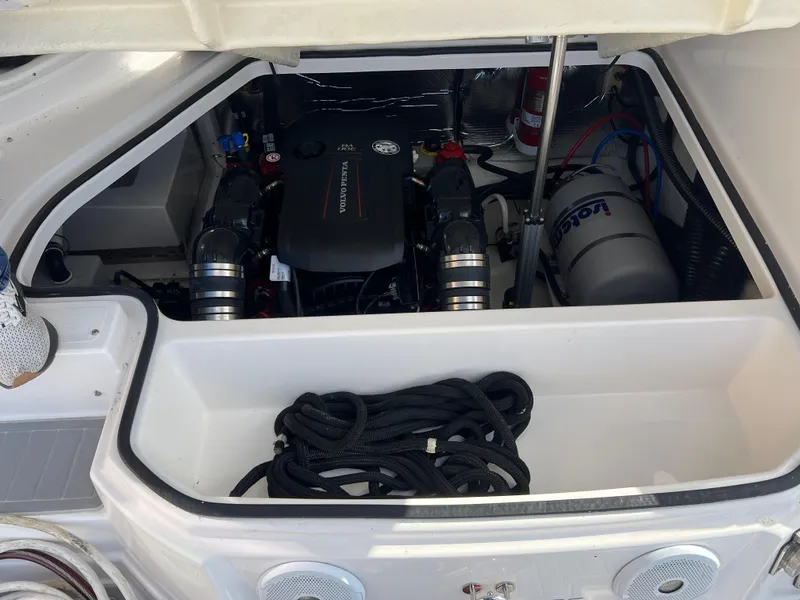 Slide: The Image of 2021 Regal 28 Express engine compartment with coiled rope and equipment. - 8