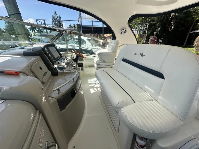 Slide: The Image of Interior of 2005 Sea Ray 420 Sundancer yacht with white seating and navigation equipment. - 17