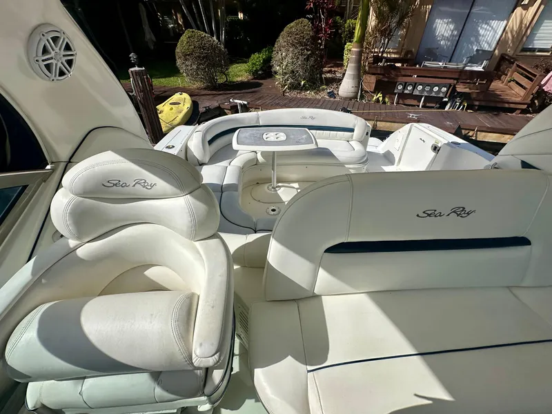 Slide: The Image of 2005 Sea Ray 420 Sundancer boat interior with white seating and table. - 18