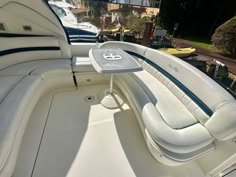 Slide: The Image of 2005 Sea Ray 420 Sundancer boat interior with white seating and table. - 21