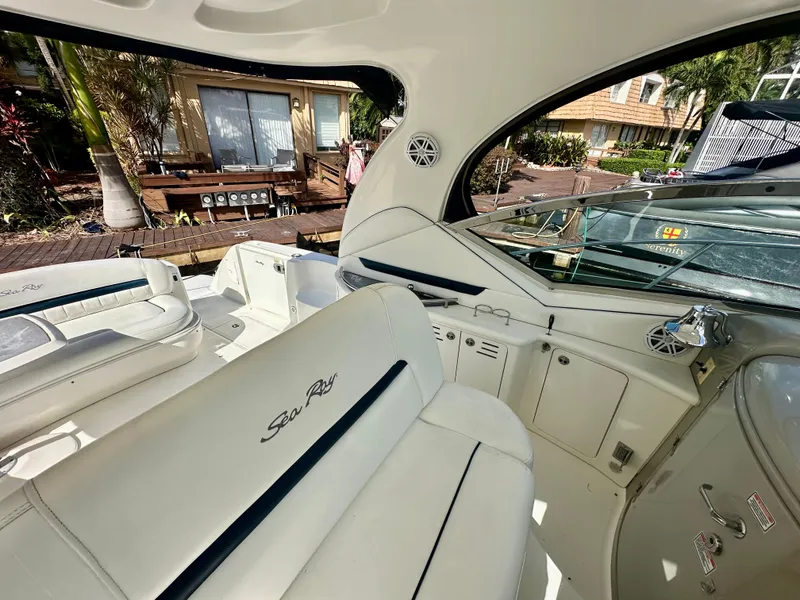 Slide: The Image of Interior of 2005 Sea Ray 420 Sundancer yacht with white seating and dashboard. - 23