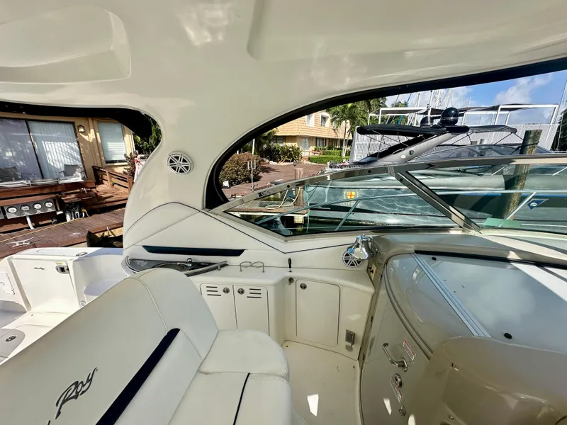 Slide: The Image of 2005 Sea Ray 420 Sundancer yacht interior with white seating and control panel. - 24