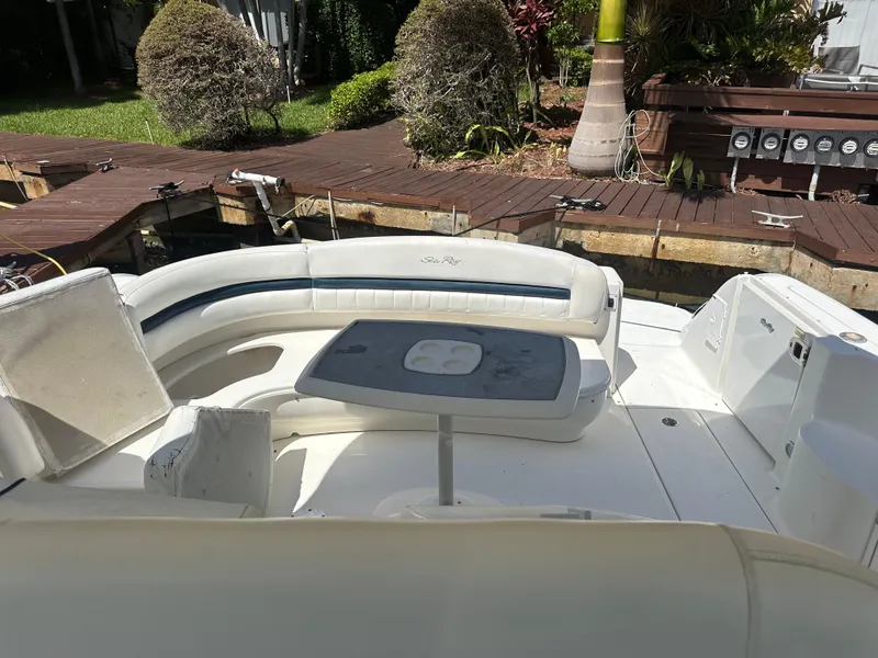 Slide: The Image of 2005 Sea Ray 420 Sundancer boat with white seating and table on deck. - 25