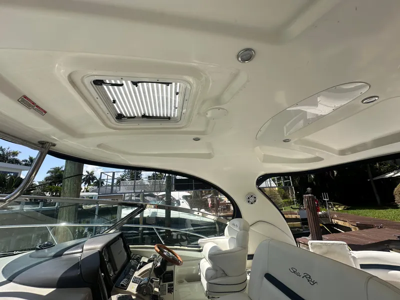 Slide: The Image of Interior view of 2005 Sea Ray 420 Sundancer yacht cockpit with helm and seating. - 26