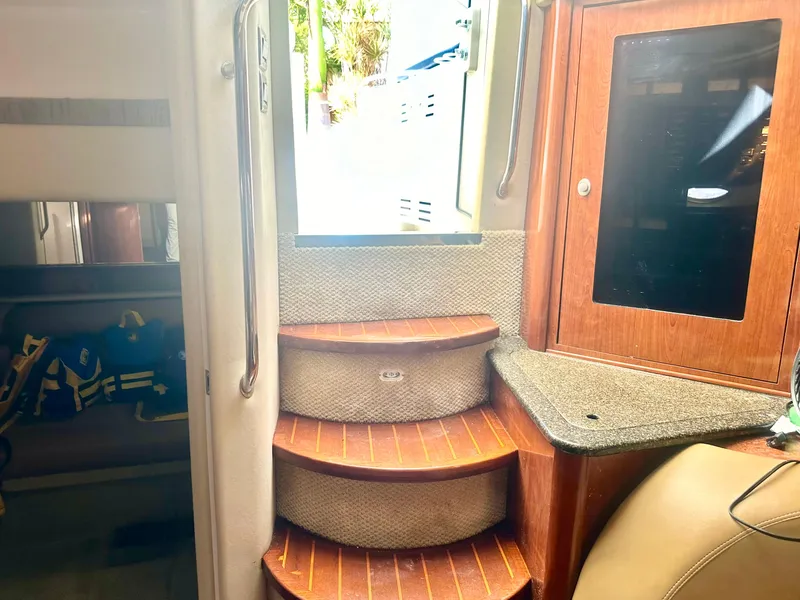 Slide: The Image of Interior of 2005 Sea Ray 420 Sundancer with wooden steps and cabin storage. - 33