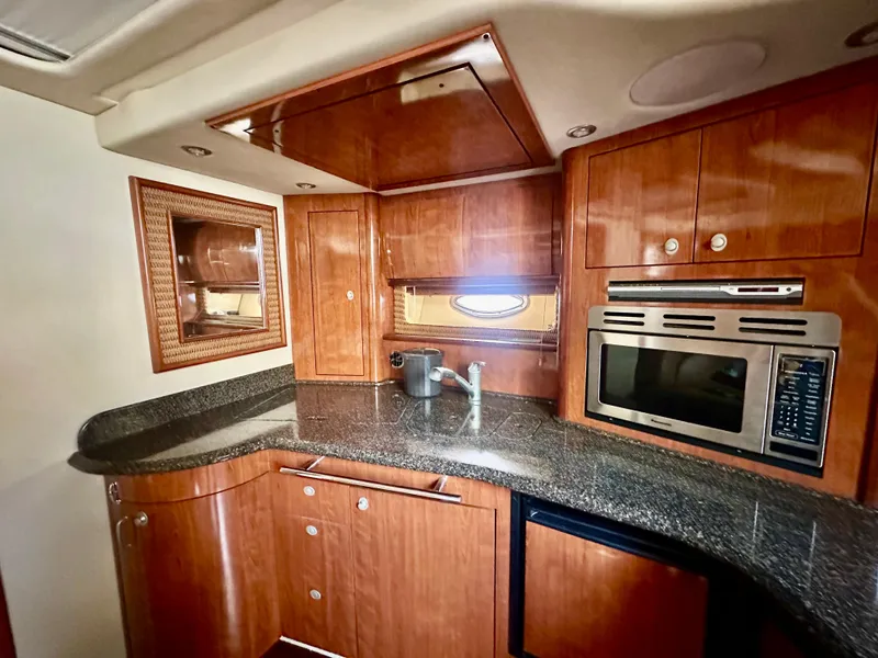 Slide: The Image of Luxurious 2005 Sea Ray 420 Sundancer yacht kitchen with wood cabinetry and modern appliances. - 37