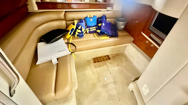 Slide: The Image of Interior of 2005 Sea Ray 420 Sundancer with life jackets on leather seating. - 38
