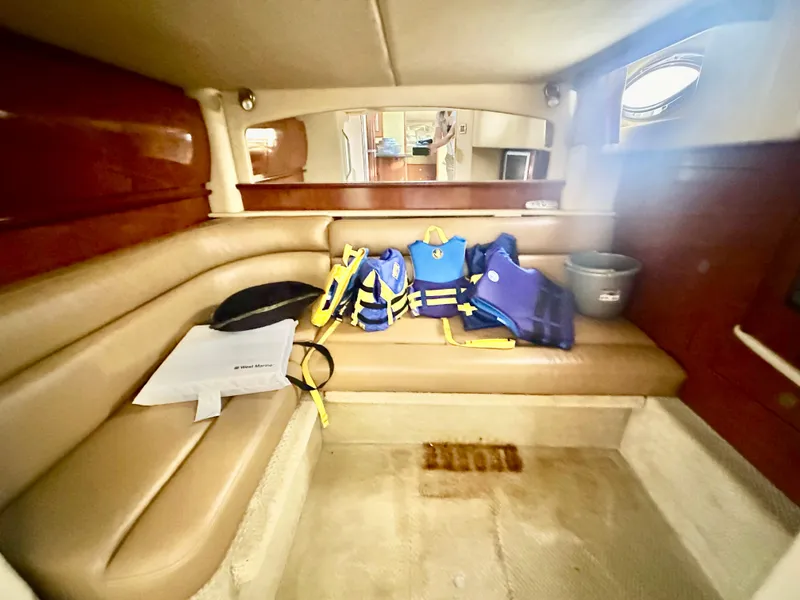 Slide: The Image of Interior of 2005 Sea Ray 420 Sundancer with life jackets on beige seating. - 39