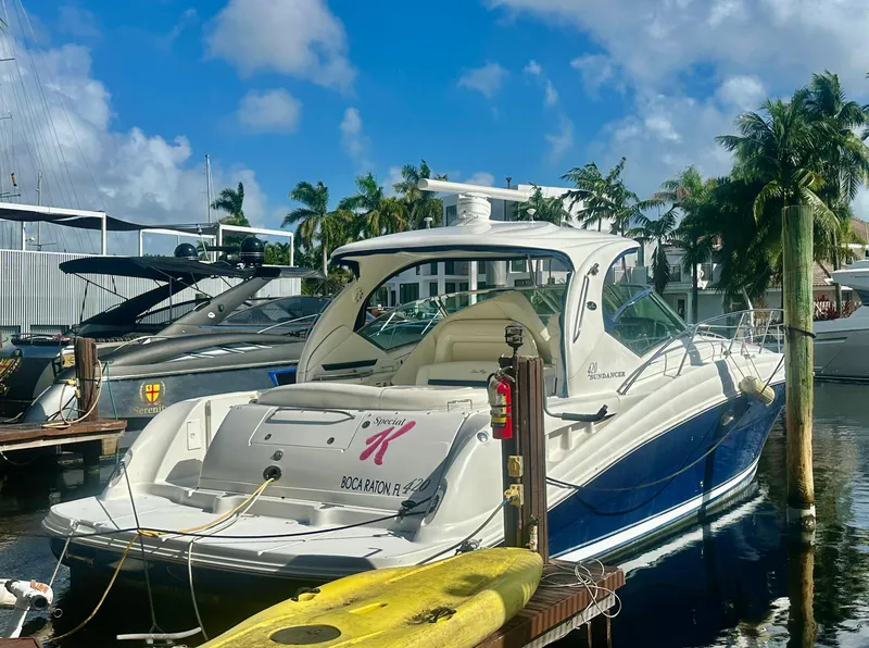 Slide: The Image of 2005 Sea Ray 420 Sundancer yacht docked in sunny marina with palm trees. - 4