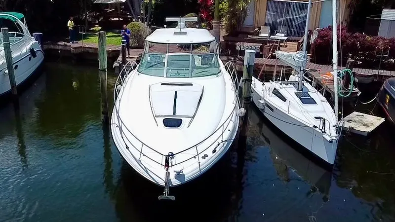 Slide: The Image of 2005 Sea Ray 420 Sundancer yacht docked beside a smaller sailboat. - 5