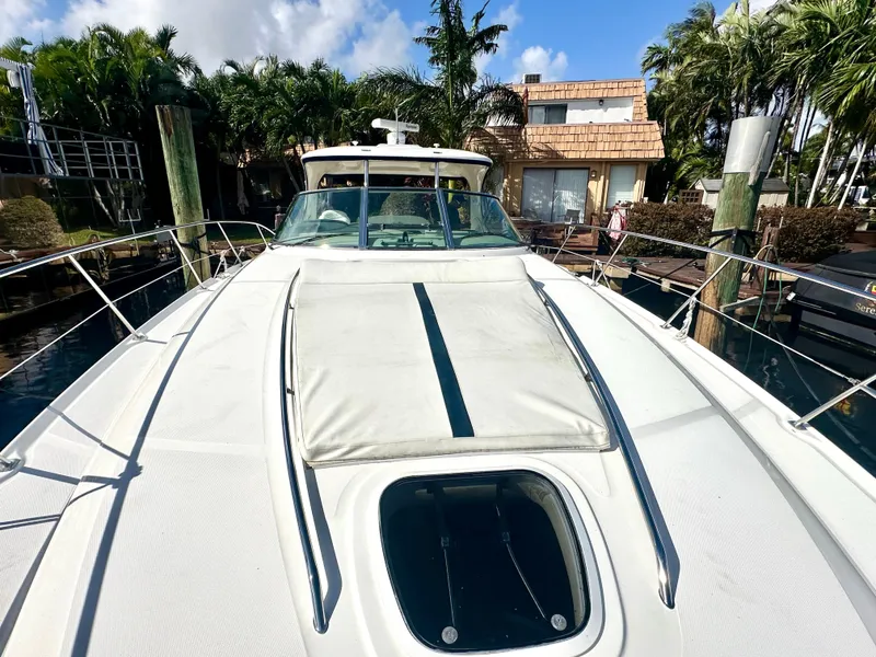 Slide: The Image of 2005 Sea Ray 420 Sundancer yacht docked near tropical waterfront home. - 8