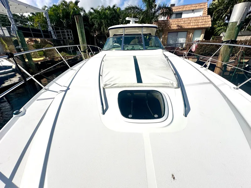 Slide: The Image of 2005 Sea Ray 420 Sundancer yacht docked, showcasing sleek deck design and luxurious features. - 9