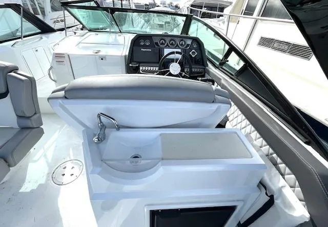Slide: The Image of 2016 Cruisers Sport Series 328CX boat interior with helm and sink. - 10
