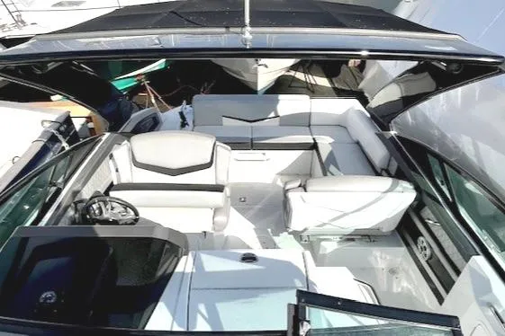 Slide: The Image of 2016 Cruisers Sport Series 328CX boat interior with white seating and black accents. - 11
