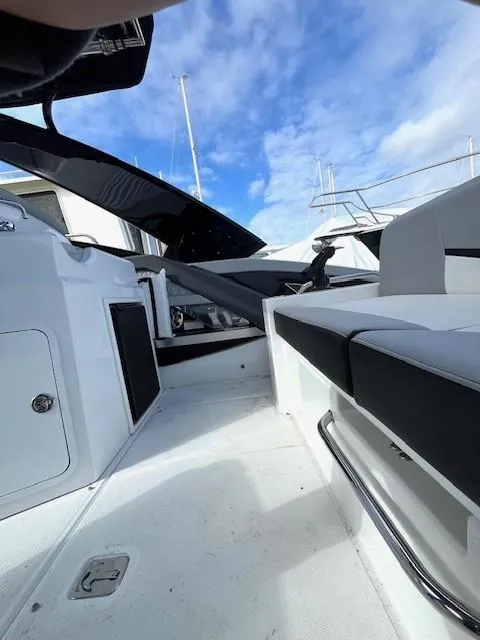 Slide: The Image of 2016 Cruisers Sport Series 328CX boat interior with seating and open deck. - 16