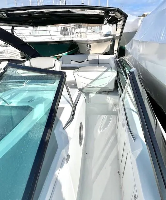 Slide: The Image of 2016 Cruisers Sport Series 328CX boat interior with seating and glass details. - 17