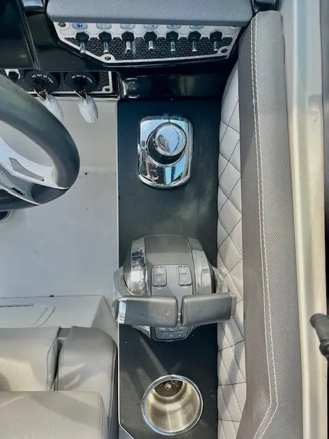 Slide: The Image of 2016 Cruisers Sport Series 328CX boat cockpit with controls and cup holder. - 21