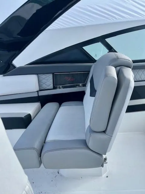 Slide: The Image of 2016 Cruisers Sport Series 328CX boat interior with gray and white seating. - 26