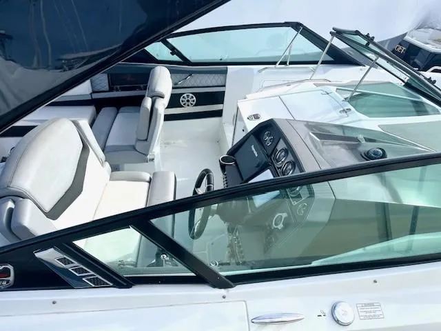Slide: The Image of 2016 Cruisers Sport Series 328CX boat interior with modern dashboard and seating. - 27