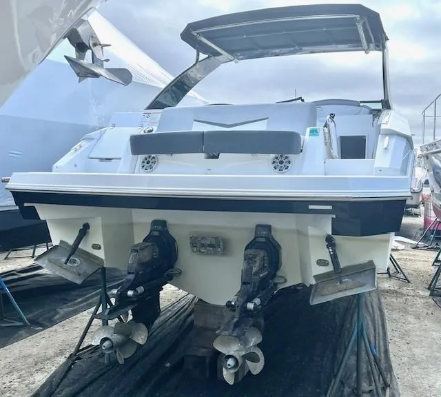 Slide: The Image of 2016 Cruisers Sport Series 328CX boat on dry dock, rear view with dual propellers. - 28