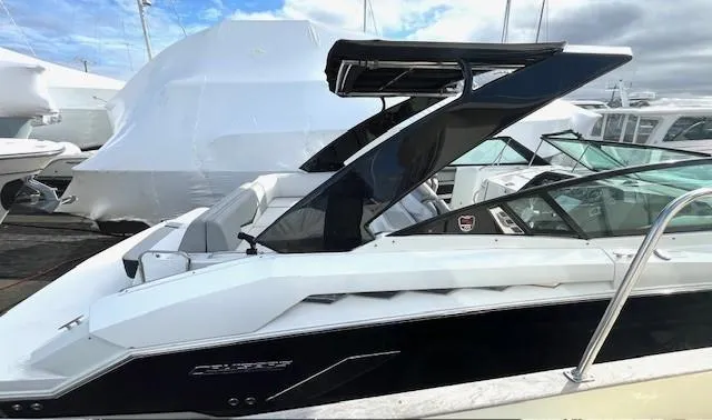 Slide: The Image of 2016 Cruisers Sport Series 328CX boat with sleek design, docked at marina. - 4