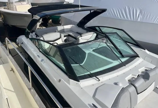 Slide: The Image of 2016 Cruisers Sport Series 328CX boat docked, featuring sleek design and spacious seating. - 5