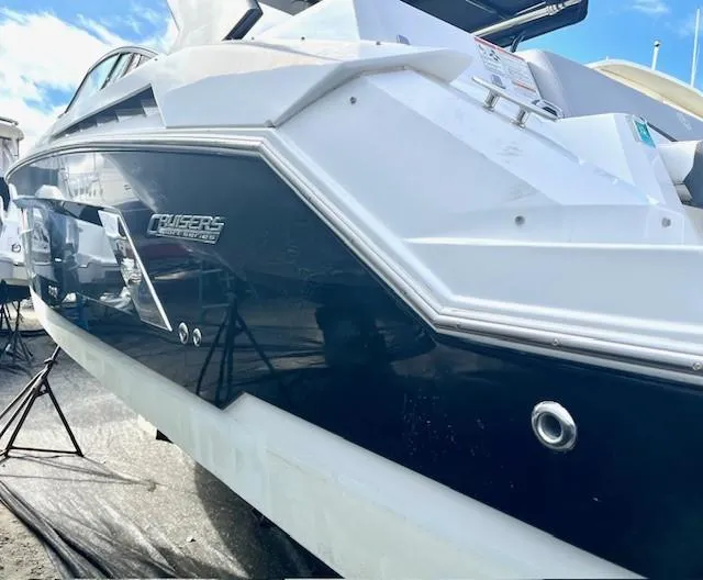 Slide: The Image of 2016 Cruisers Sport Series 328CX boat, sleek design, docked under blue sky. - 6