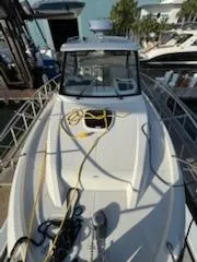 Slide: The Image of 2023 Boston Whaler 325 Conquest boat docked with ropes on deck. - 49