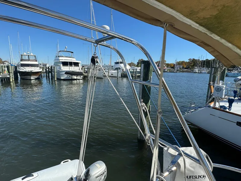 Slide: The Image of Beneteau 50 sailboat docked in a marina, 2002 model, with clear blue sky. - 11