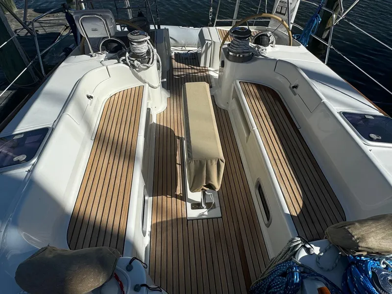 Slide: The Image of Spacious deck of 2002 Beneteau 50 sailboat with teak flooring and seating. - 12