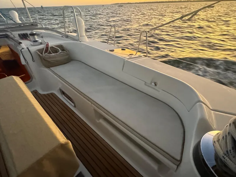 Slide: The Image of Beneteau 50 sailboat deck at sunset, 2002 model, with ocean view. - 13