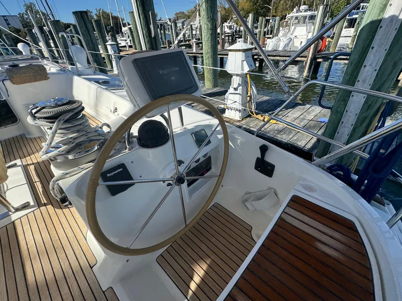 Slide: The Image of Beneteau 50 sailboat cockpit with steering wheel, docked at marina, 2002 model. - 14