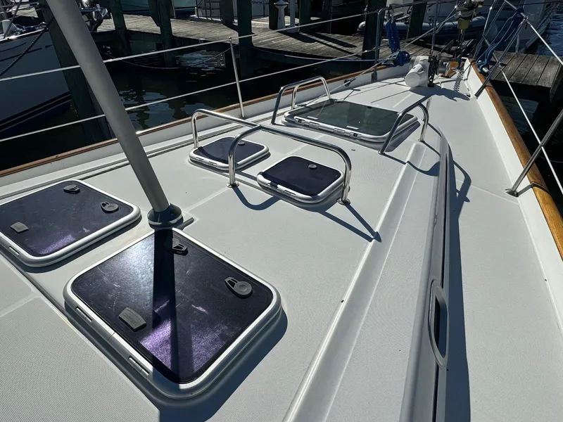 Slide: The Image of Deck view of 2002 Beneteau 50 sailboat with hatches and railings. - 16