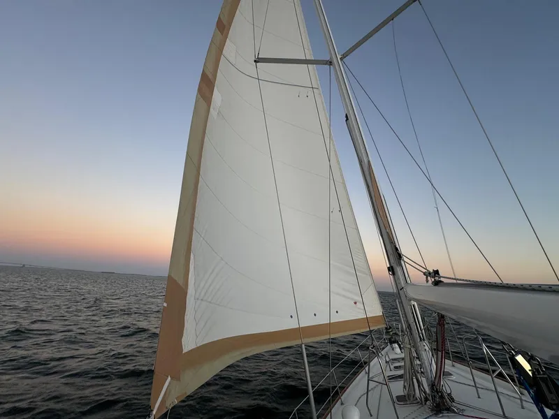 Slide: The Image of Sailing on a 2002 Beneteau 50 at sunset, open sea view. - 17