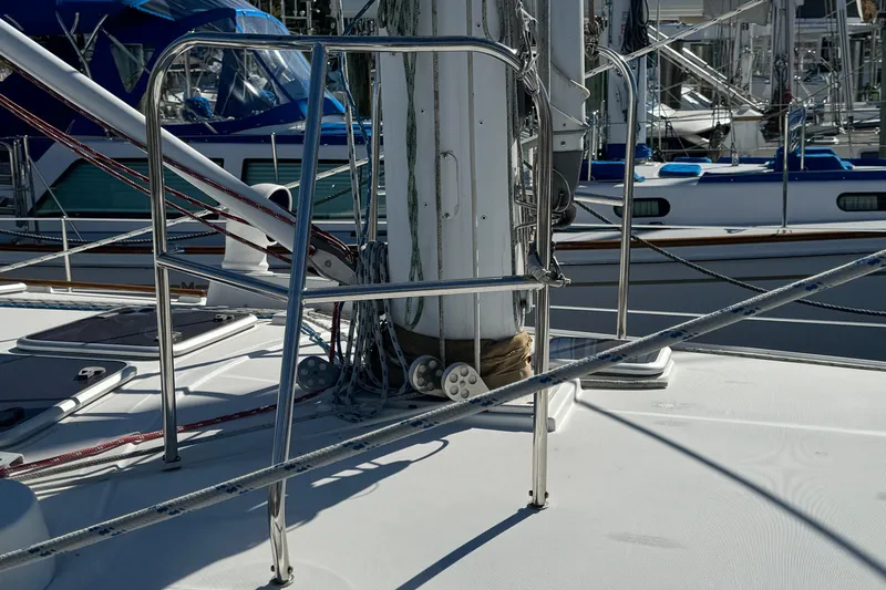 Slide: The Image of Beneteau 50 sailboat deck with rigging and railings, 2002 model, docked in marina. - 22