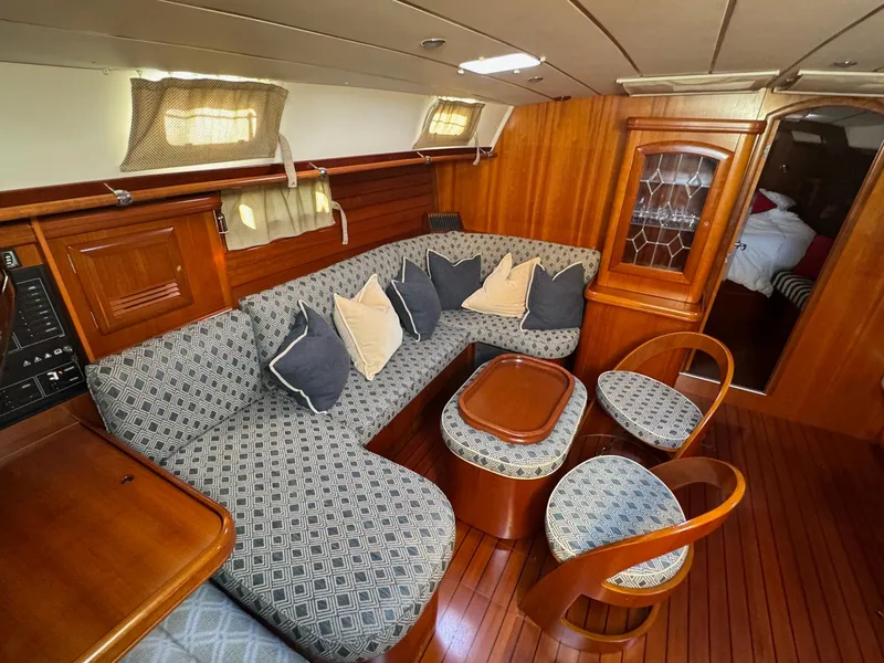 Slide: The Image of Luxurious interior of a 2002 Beneteau 50 yacht with elegant wood finish and plush seating. - 24