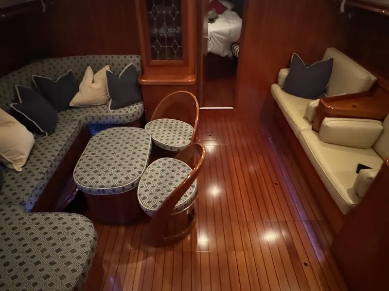 Slide: The Image of Interior of 2002 Beneteau 50 yacht with elegant wood flooring and cozy seating. - 25