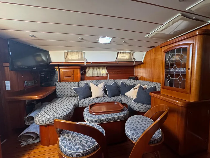 Slide: The Image of Luxurious 2002 Beneteau 50 yacht interior with elegant wood finish and cozy seating area. - 26