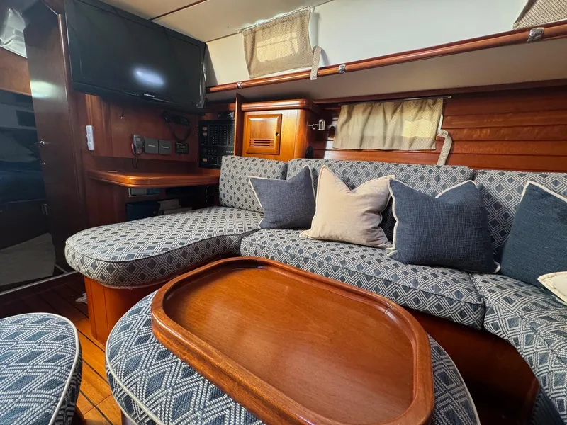 Slide: The Image of Luxurious interior of 2002 Beneteau 50 yacht with plush seating and wooden accents. - 27