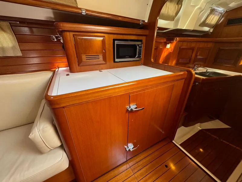 Slide: The Image of Interior of 2002 Beneteau 50 yacht with wooden cabinetry and modern amenities. - 30