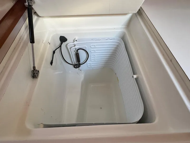 Slide: The Image of Beneteau 50 (2002) yacht refrigerator compartment, open and empty. - 36